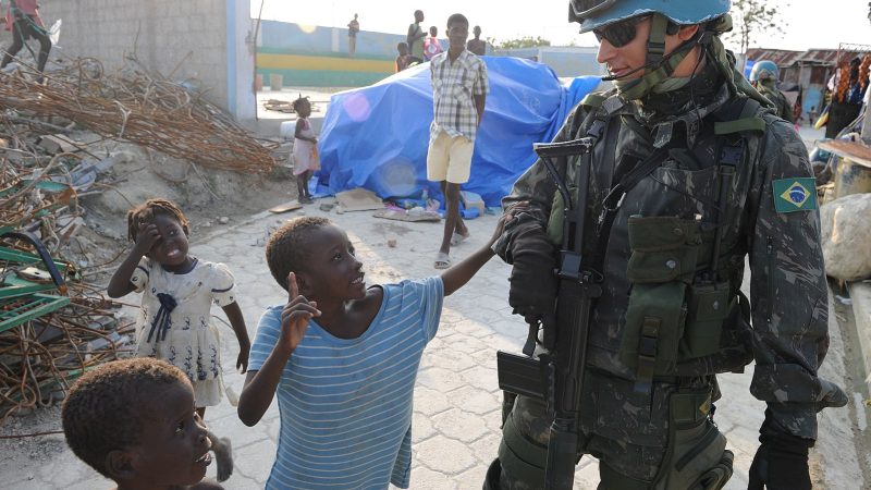 PORT-AU-PRINCE, Haiti (March 16, 2010) A Brazilian U.N. peacekeeper walks with Haitian children during a patrol in Cite Soleil, a section of Port-au-Prince. Several U.S. and international military and non-governmental agencies are conducting humanitarian and disaster relief operations as part of Operation Unified Response after a 7.0-magnitude earthquake caused severe damage in and around Port-au-Prince, Haiti Jan. 12. (U.S. Navy photo by Mass Communication Specialist 1st Class David A. Frech/Released)